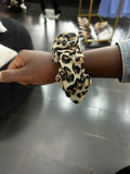 Leopard print scrunchie on a wrist